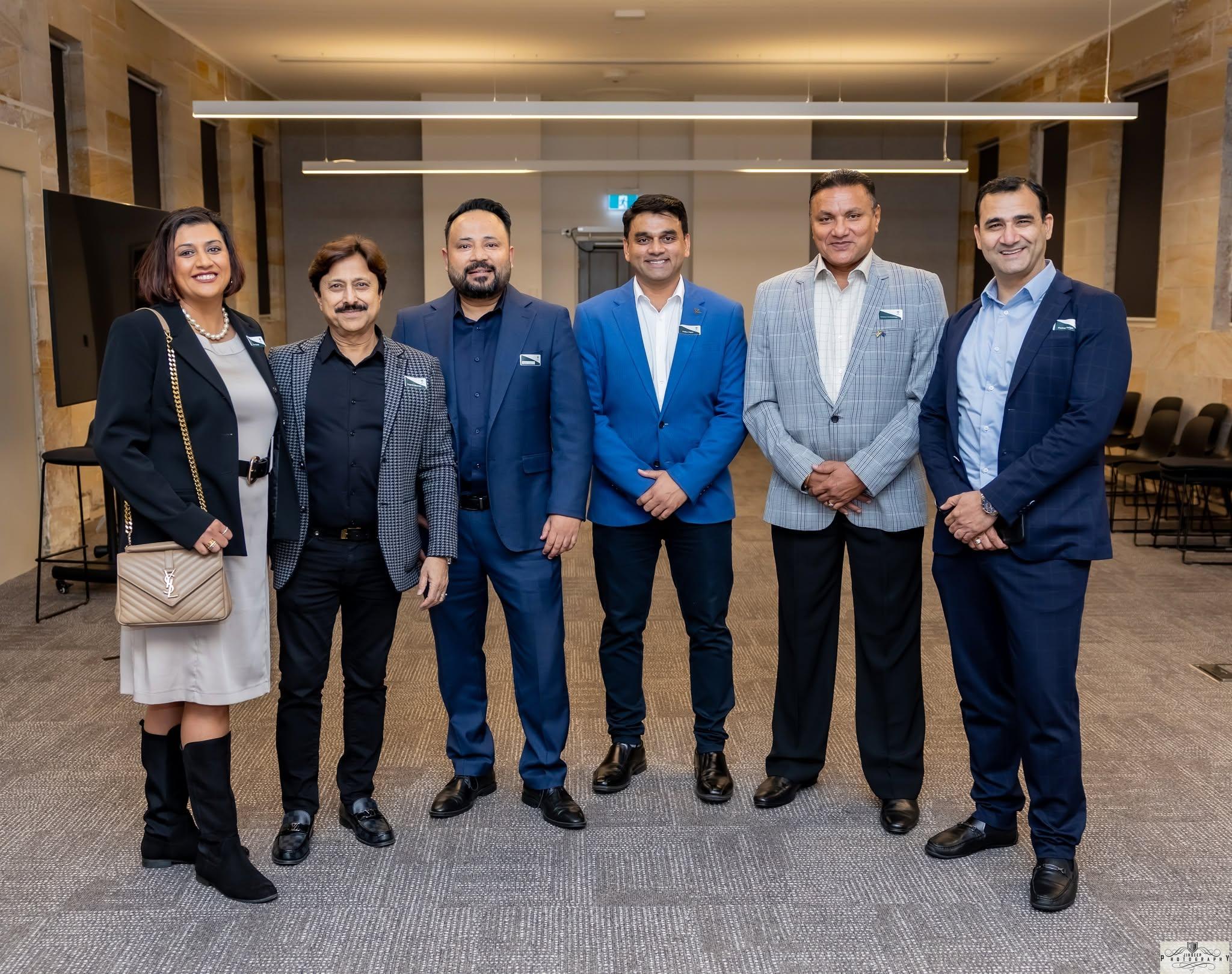 Six members lined up together at an Artha function room event